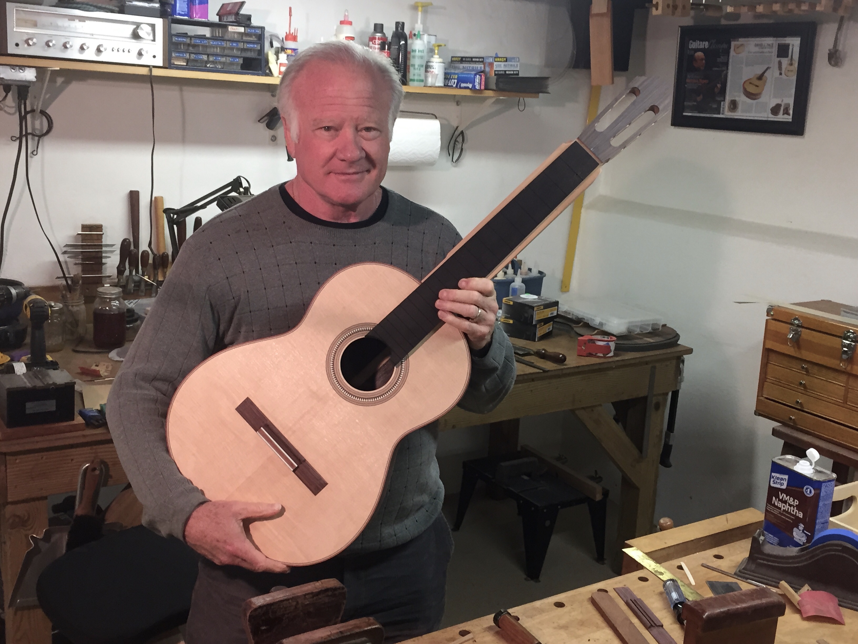 Guitarist Gordon Kreplin in a luthier's shop