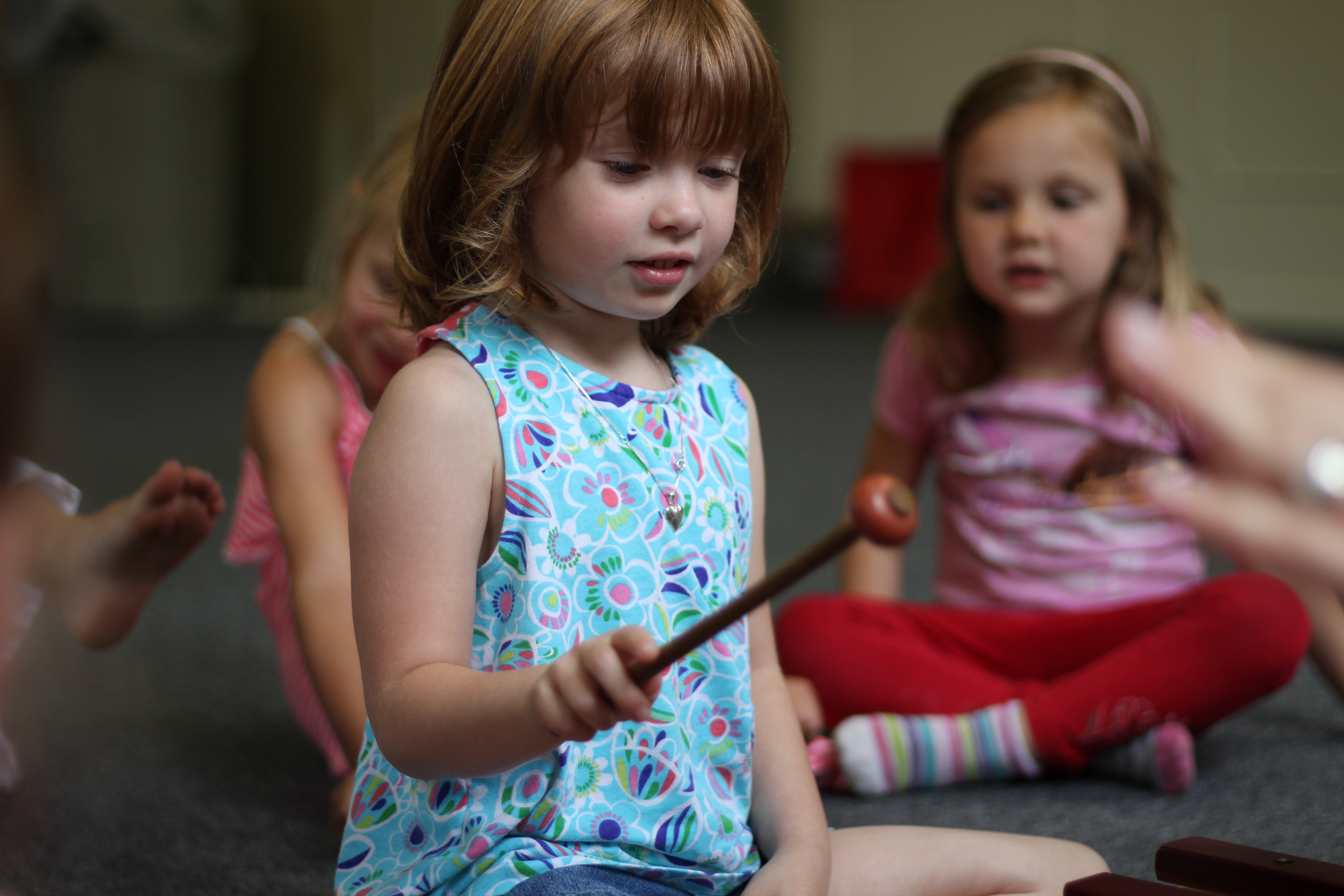 young girl playing a xylophone