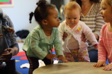 toddler touching a drum