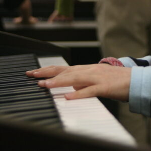 child's hands on a piano keyboard