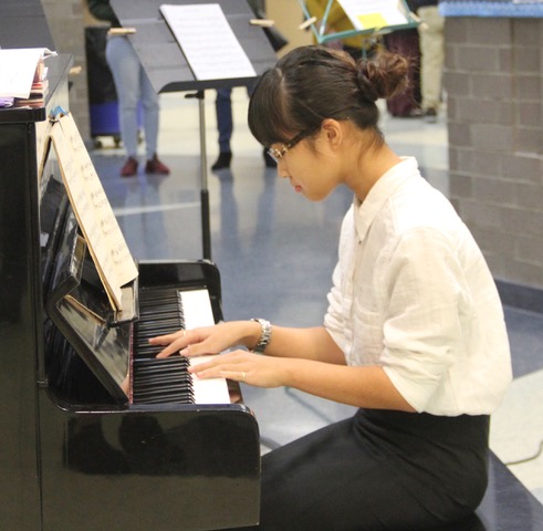 Student Concerts in 2020 - live. Young woman playing piano.